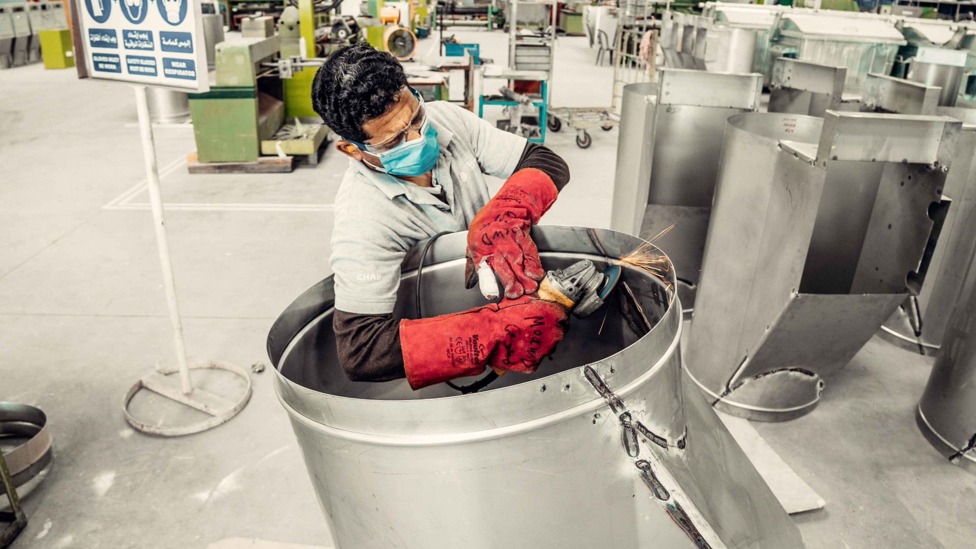 man-trimming-the-edges-of-a-garbage-chute-tube