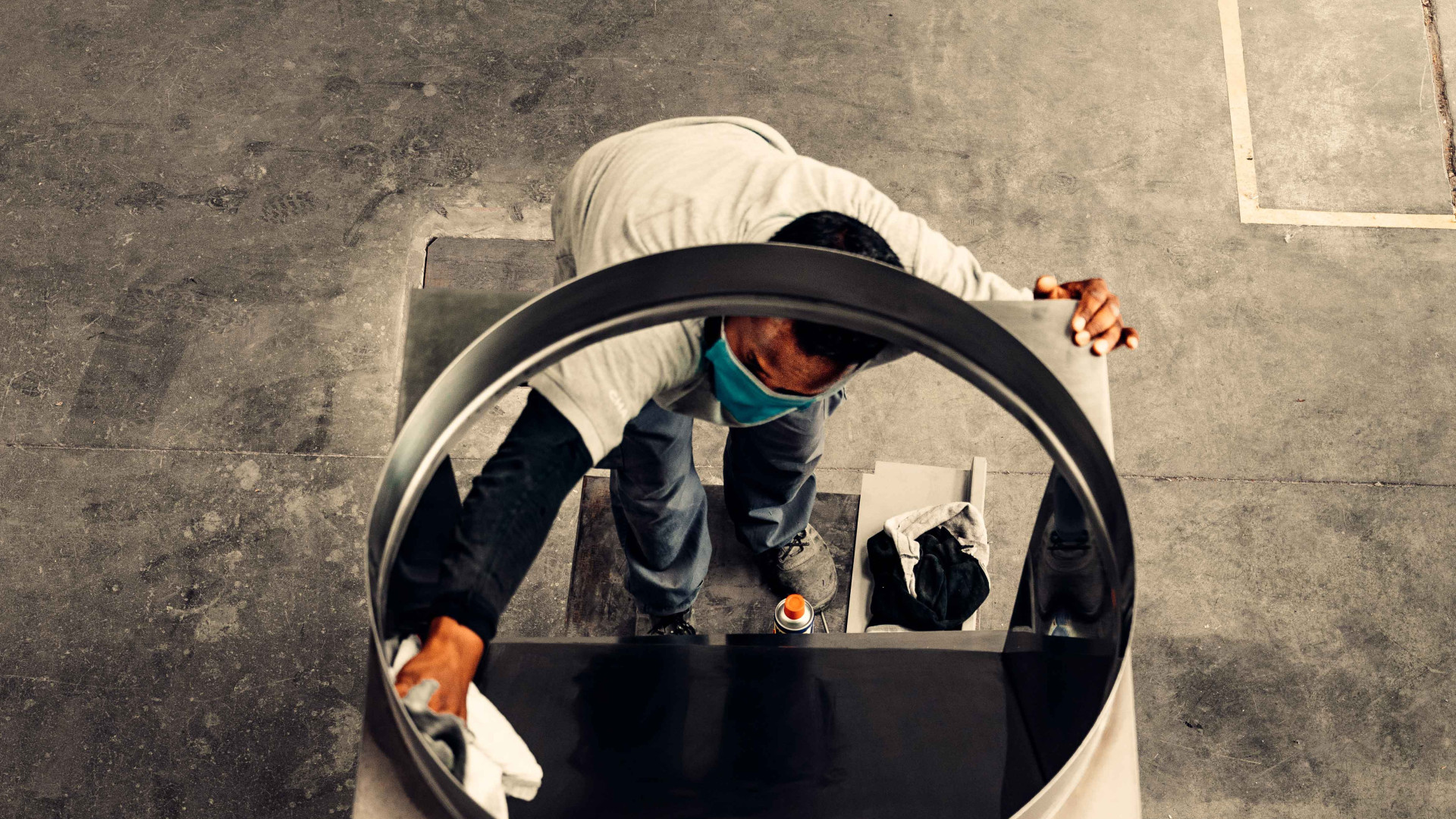 man-wiping-the-insides-of-a-garbage-chute